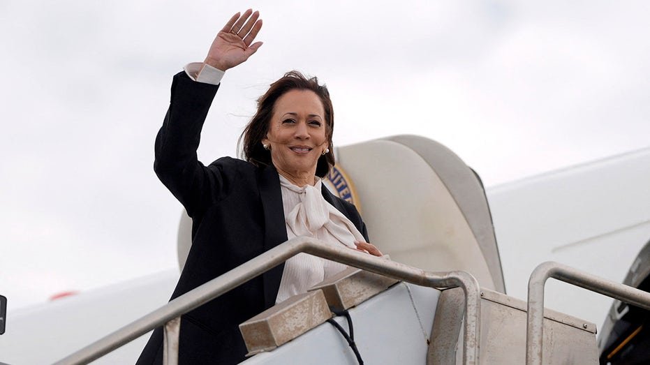 Kamala Harris waves on steps of Air Force Two